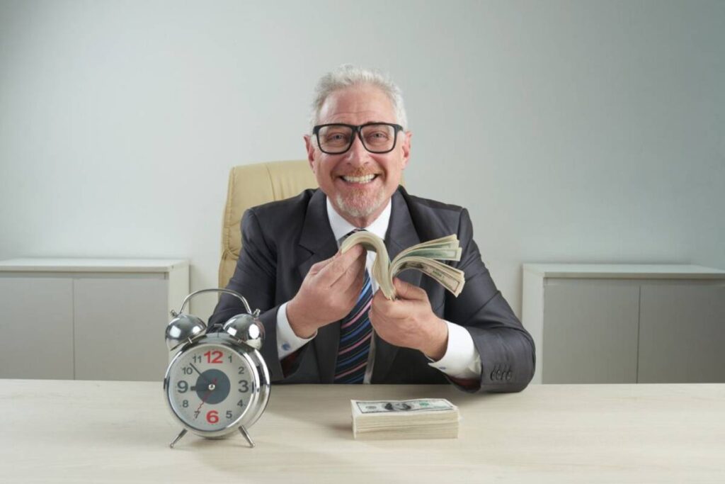 A businessman in a suit is counting cash at a desk, with a vintage clock beside him, reflecting a sense of urgency and finance.