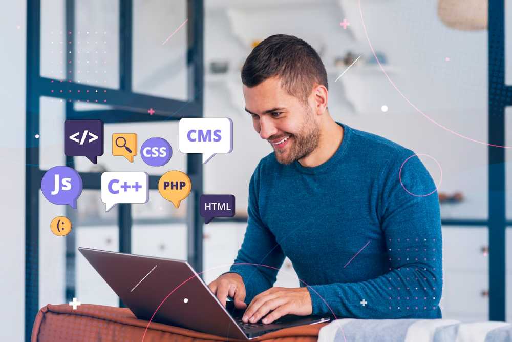 A software developer works on a laptop surrounded by colorful speech bubbles representing various programming languages and concepts.