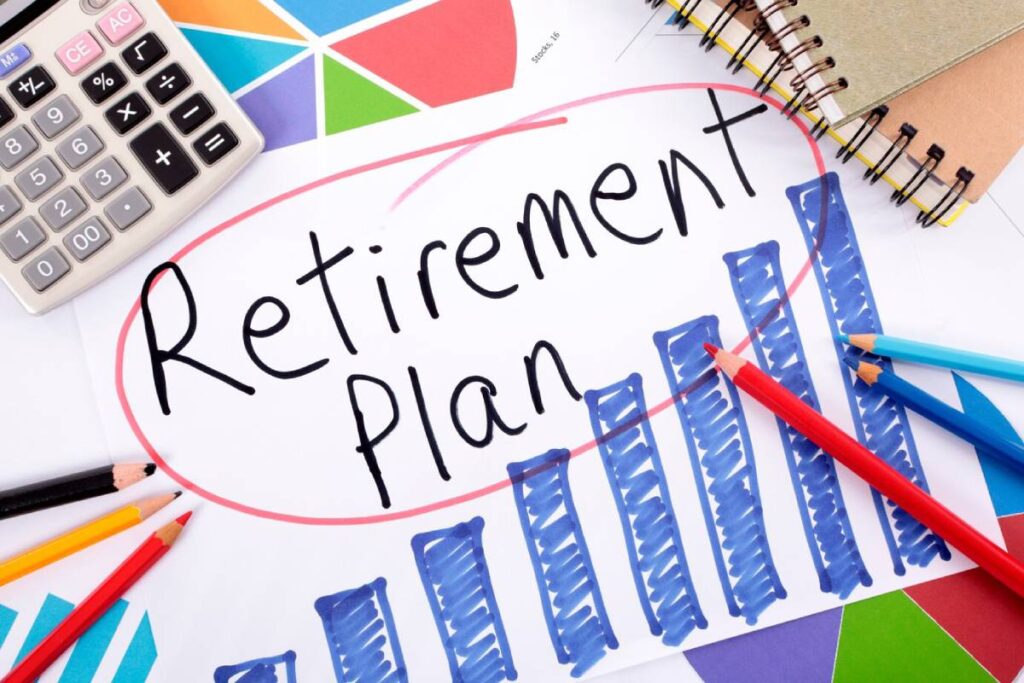 A calculator, colored pencils, and sketches surround a paper marked "Retirement Plan" with a graph illustrating growth.
