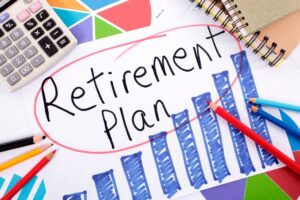 A calculator, colored pencils, and sketches surround a paper marked "Retirement Plan" with a graph illustrating growth.