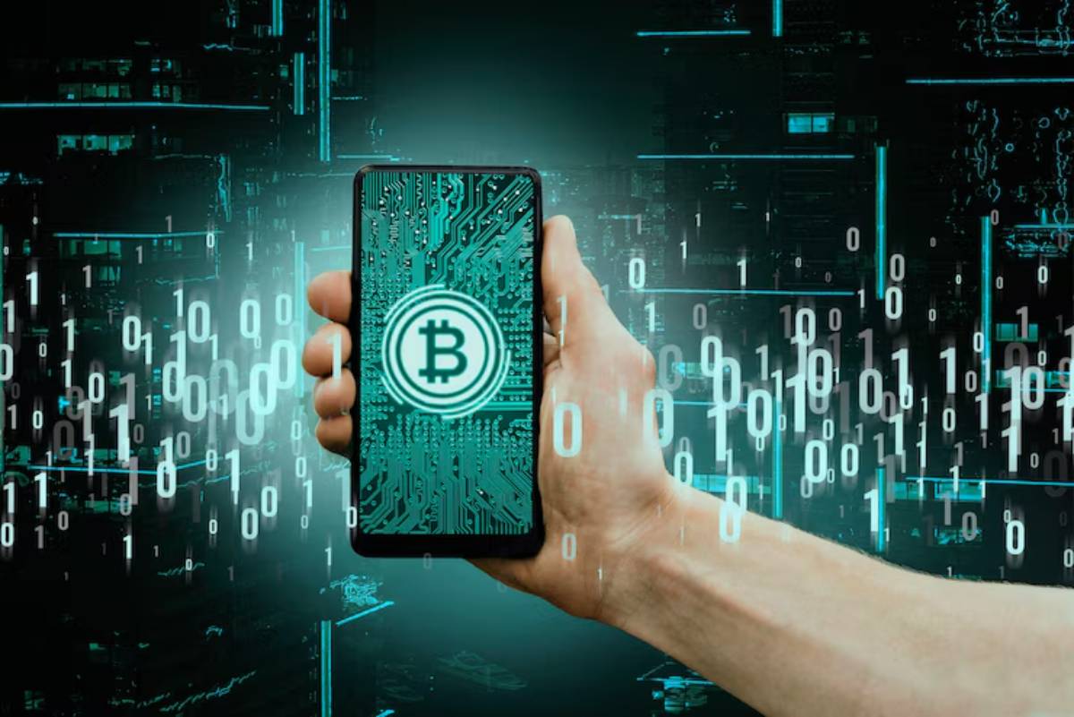 A hand holding a smartphone displaying a Bitcoin logo, surrounded by digital binary code and a futuristic backdrop.